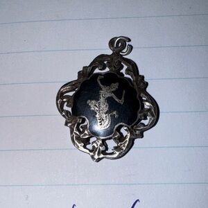 Silver and Black Pendant with Intricate Design